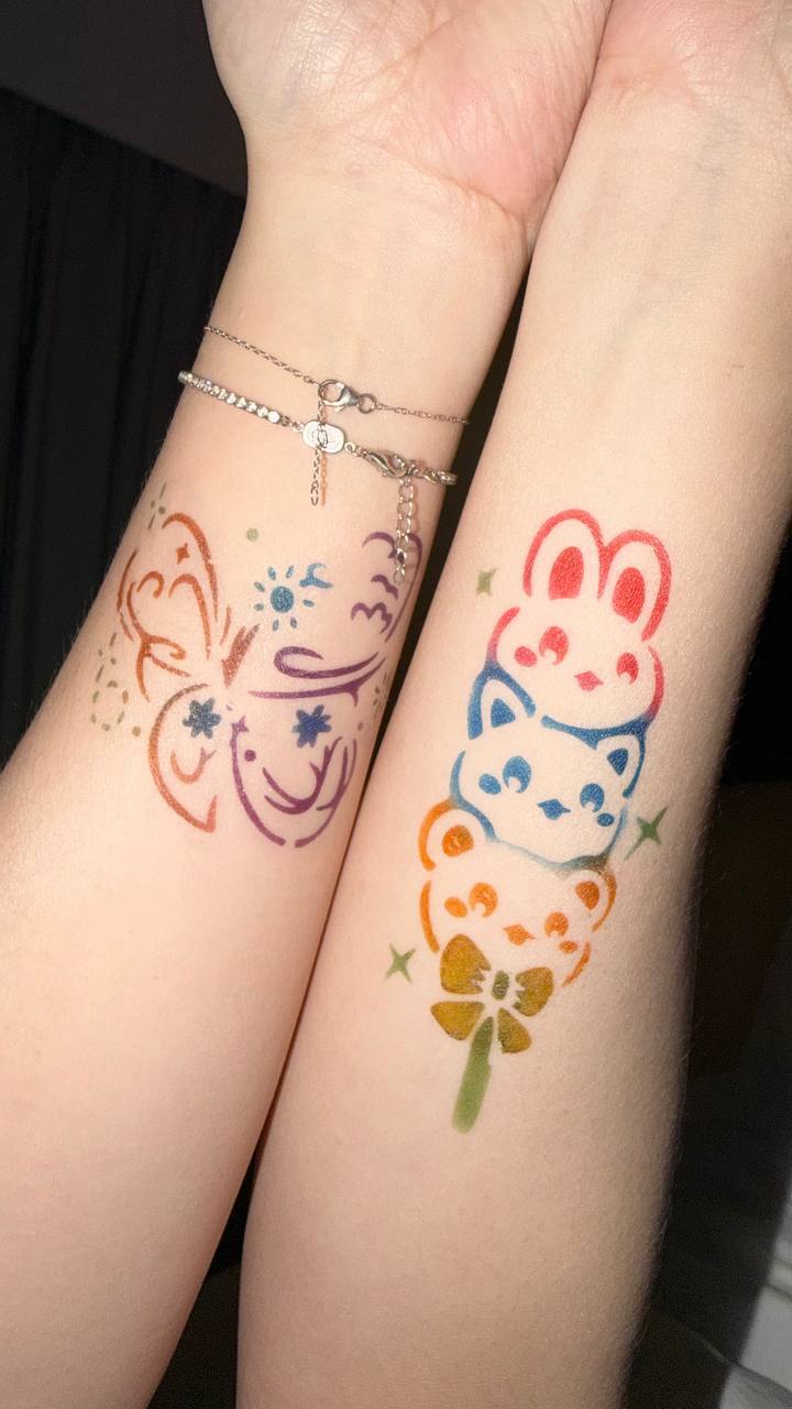Colorful airbrush tattoos on wrist