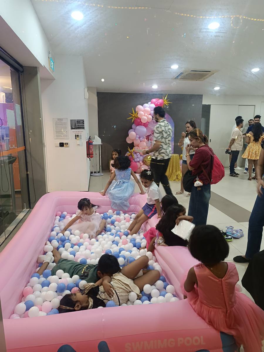Kids playing in pink ball pit