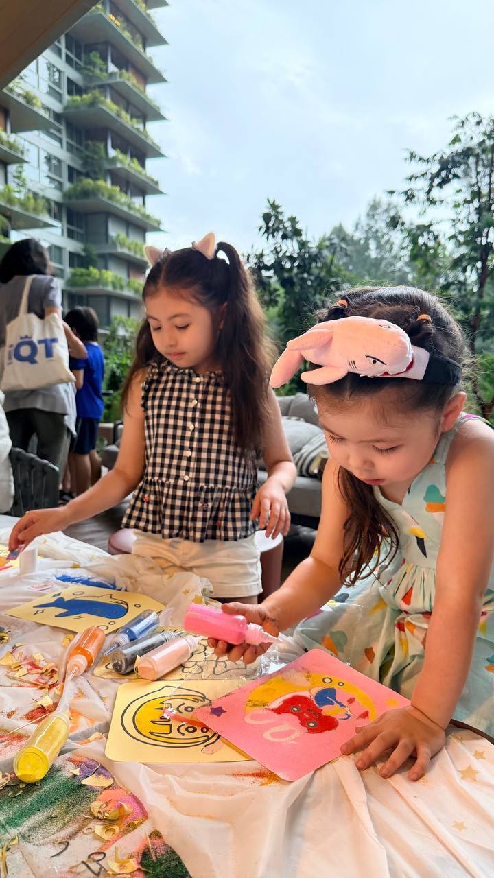 Kids concentrating on sand art outdoor